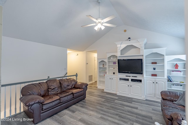 living room featuring ceiling fan, hardwood / wood-style flooring, and vaulted ceiling