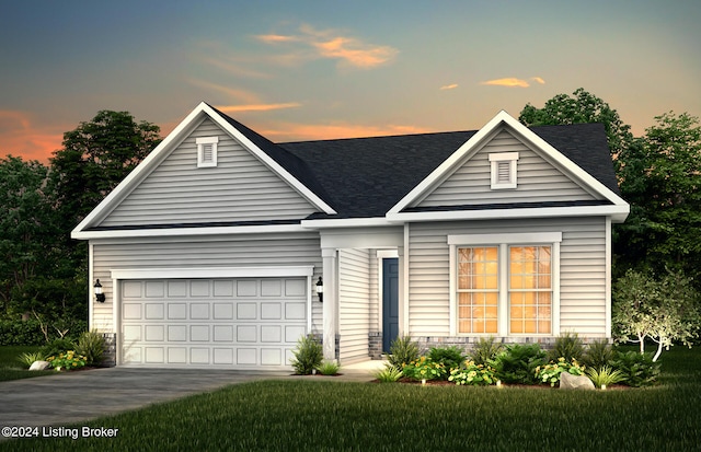 view of front facade featuring a lawn and a garage