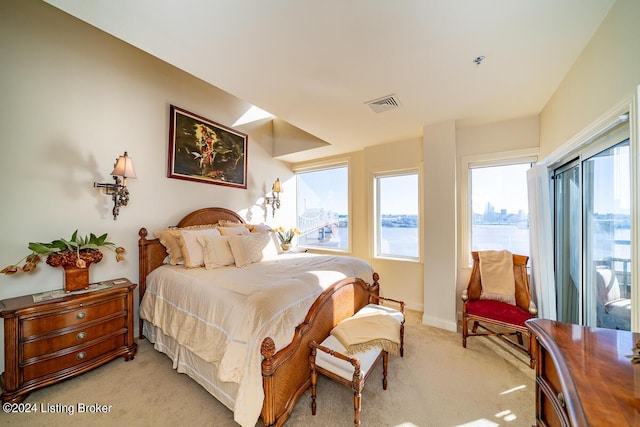 bedroom with light carpet, visible vents, and baseboards