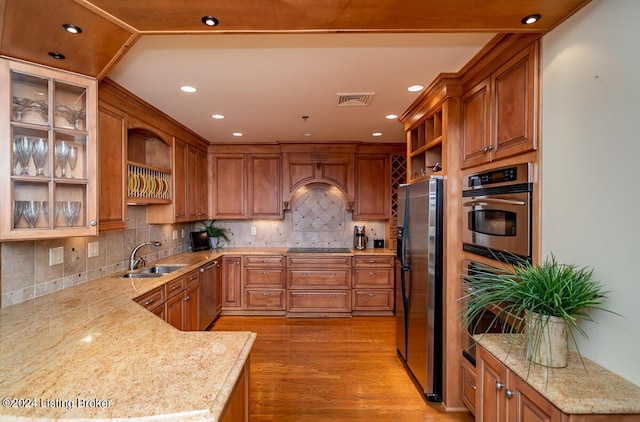 kitchen featuring open shelves, custom exhaust hood, stainless steel appliances, and a sink