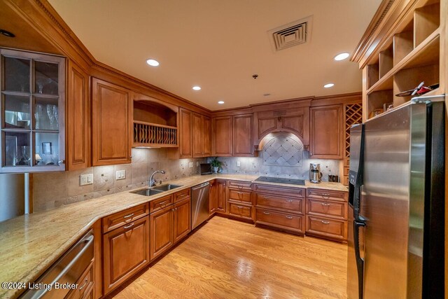 kitchen featuring open shelves, stainless steel appliances, visible vents, brown cabinetry, and a sink