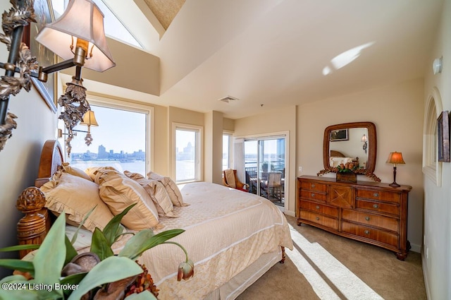 carpeted bedroom with baseboards, a view of city, and visible vents