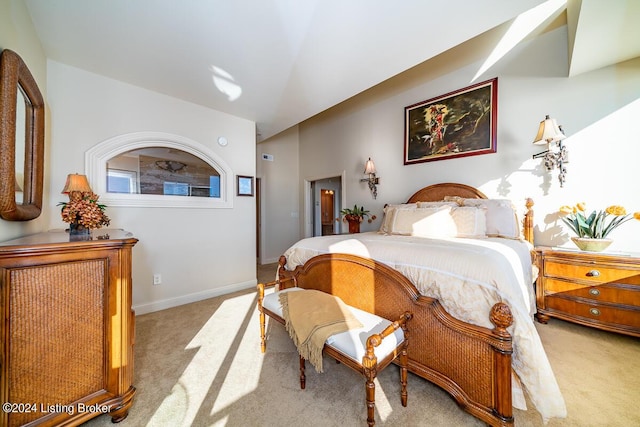 bedroom featuring light carpet and baseboards