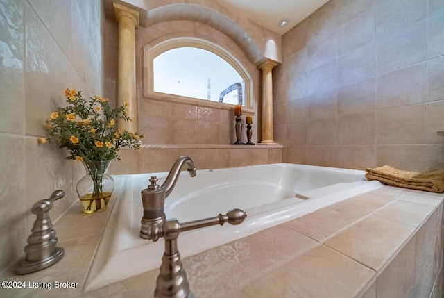 bathroom featuring a garden tub and tile walls