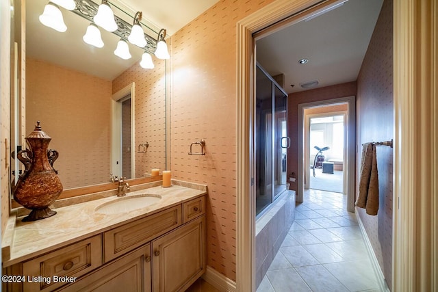 bathroom with wallpapered walls, tile patterned flooring, baseboards, and vanity