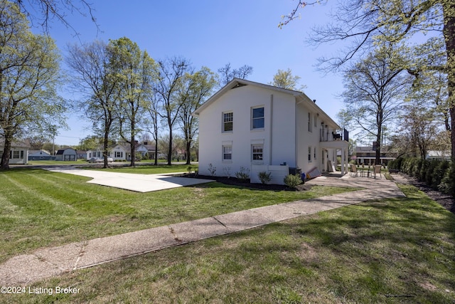 view of side of home featuring a yard