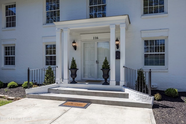 view of exterior entry featuring a porch