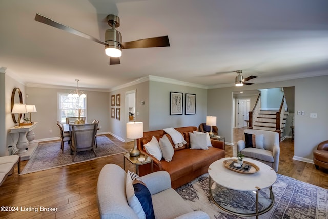 living room featuring ceiling fan with notable chandelier, crown molding, and hardwood / wood-style floors