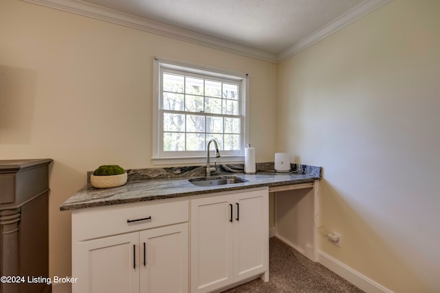 kitchen featuring white cabinetry, carpet floors, stone counters, and sink