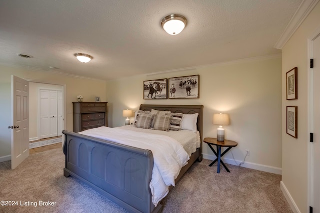 carpeted bedroom with a closet and crown molding