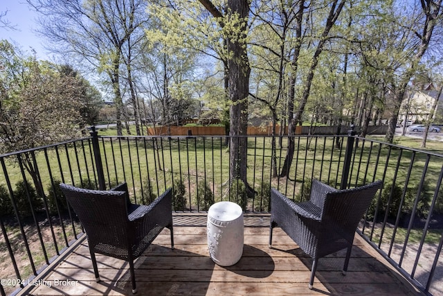 wooden deck with a lawn