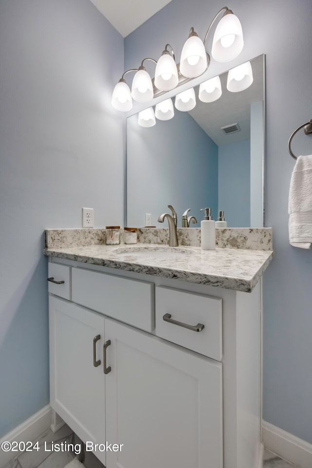 bathroom with tile patterned flooring and vanity