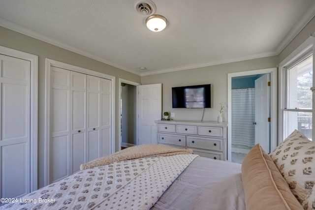 bedroom with connected bathroom and ornamental molding