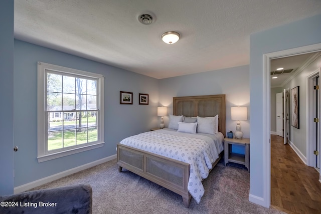 carpeted bedroom with a textured ceiling