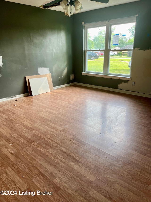 empty room featuring ceiling fan and hardwood / wood-style floors