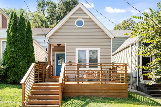 rear view of property featuring a wooden deck