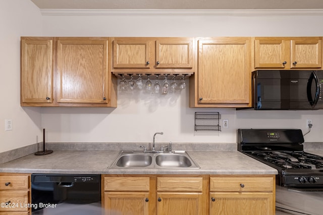 kitchen with black appliances, a sink, light countertops, and crown molding