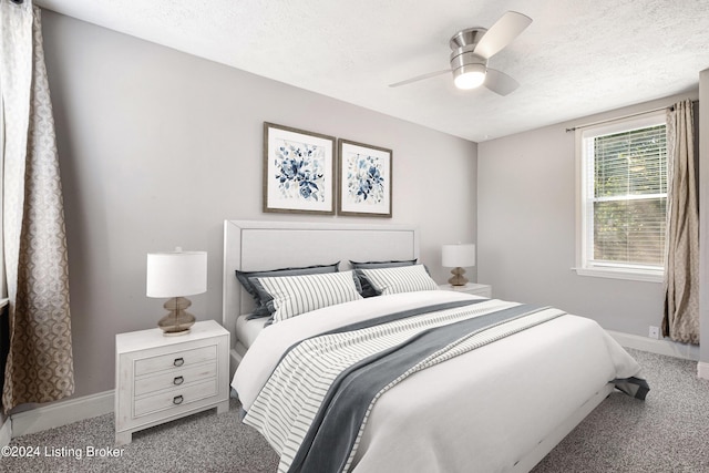 bedroom with light colored carpet, ceiling fan, a textured ceiling, and baseboards