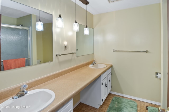 bathroom featuring walk in shower, vanity, and tile patterned flooring