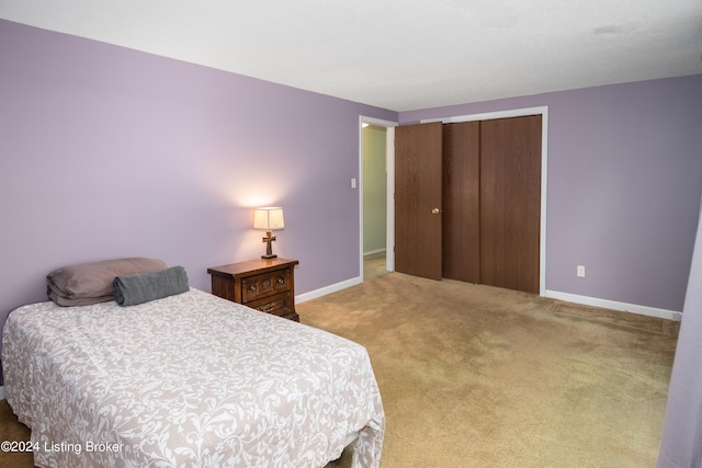 carpeted bedroom with a closet