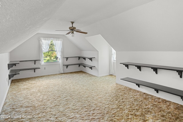 bonus room with ceiling fan, vaulted ceiling, a textured ceiling, and carpet flooring