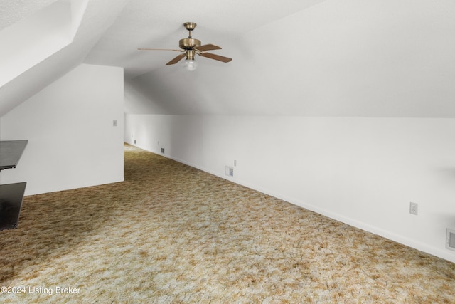 additional living space featuring ceiling fan, carpet floors, and vaulted ceiling