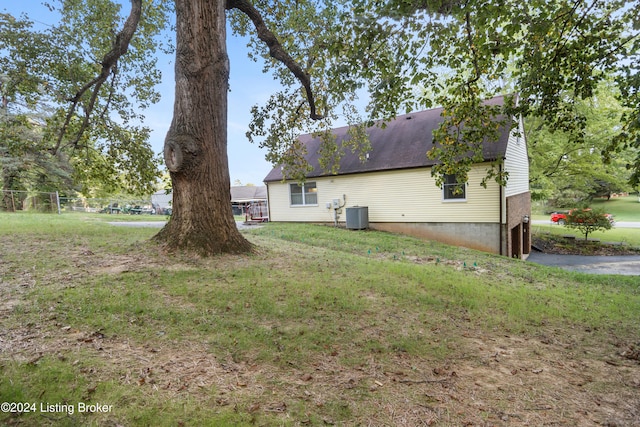 exterior space featuring a yard and central AC