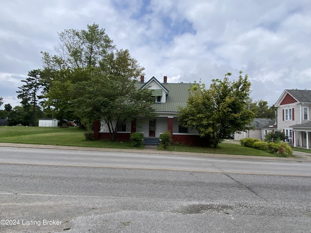 obstructed view of property featuring a front yard