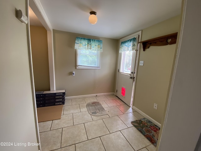 doorway to outside featuring light tile patterned floors