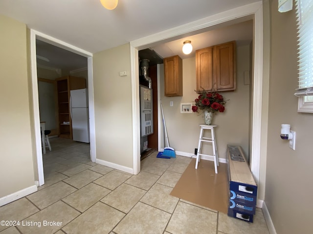 kitchen with white refrigerator and light tile patterned flooring