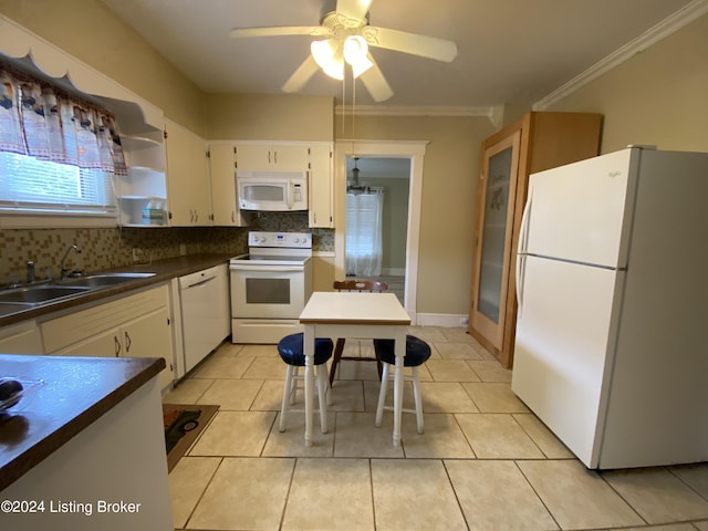 kitchen featuring sink, backsplash, light tile patterned floors, crown molding, and white appliances