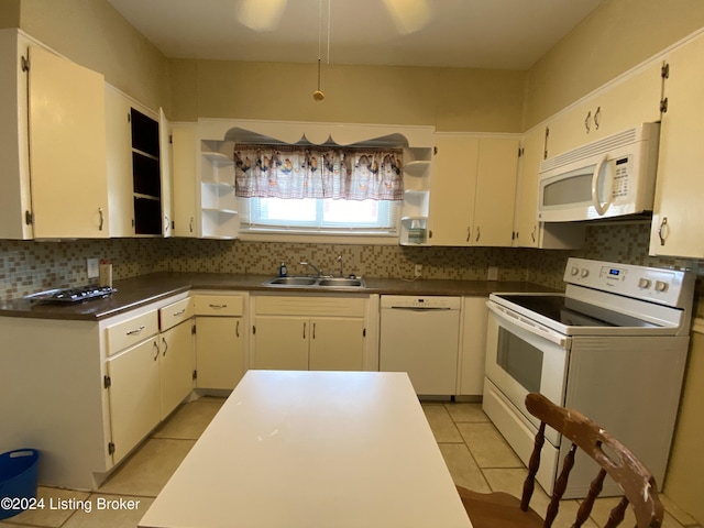 kitchen featuring light tile patterned flooring, sink, white cabinetry, white appliances, and backsplash