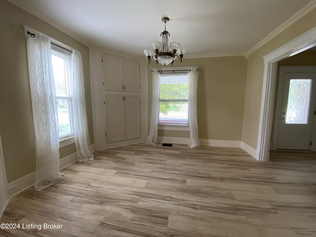 unfurnished dining area featuring crown molding, a chandelier, and light wood-type flooring