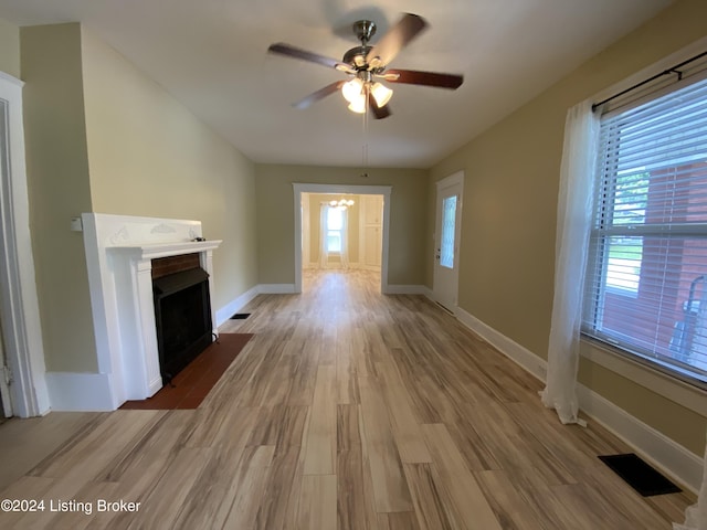 unfurnished living room featuring hardwood / wood-style floors and ceiling fan