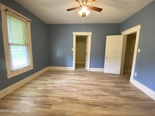 empty room featuring ceiling fan and light wood-type flooring