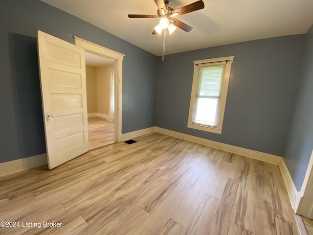 empty room featuring ceiling fan and light hardwood / wood-style floors