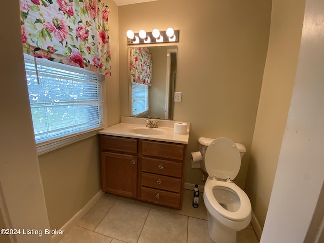 bathroom featuring vanity, toilet, and tile patterned flooring