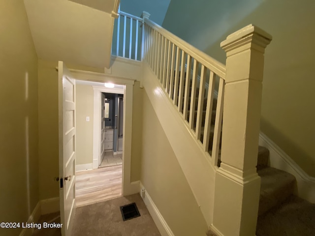 stairway with a high ceiling and carpet