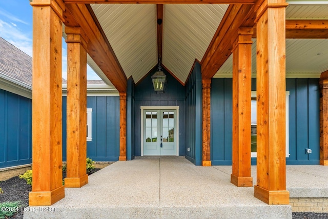 property entrance with a shingled roof, board and batten siding, and french doors