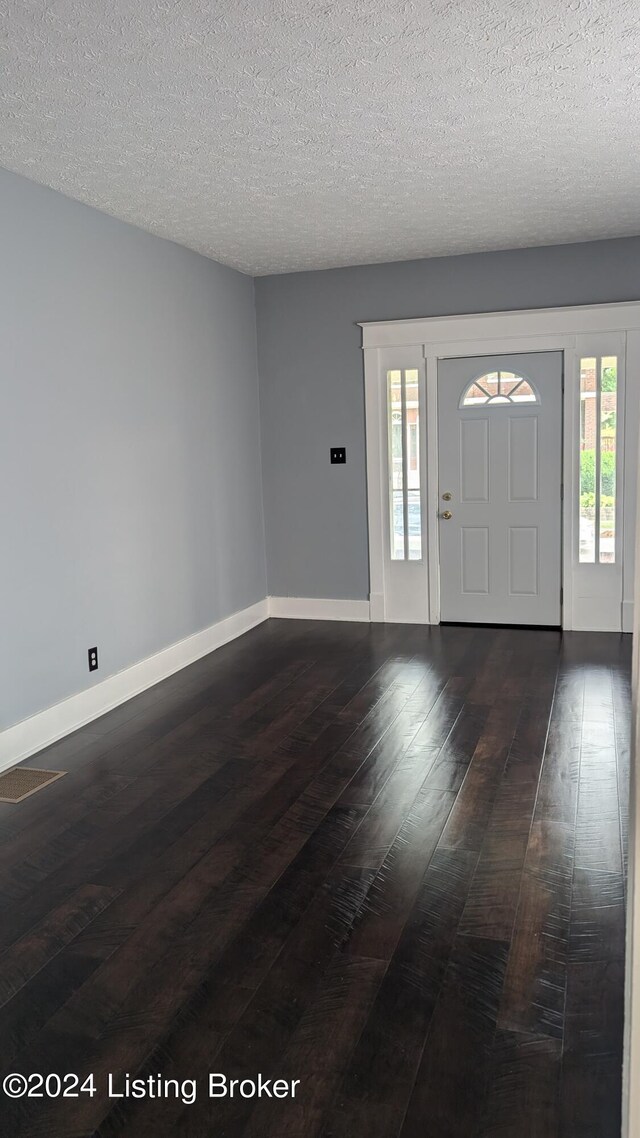 entrance foyer featuring hardwood / wood-style flooring and a textured ceiling