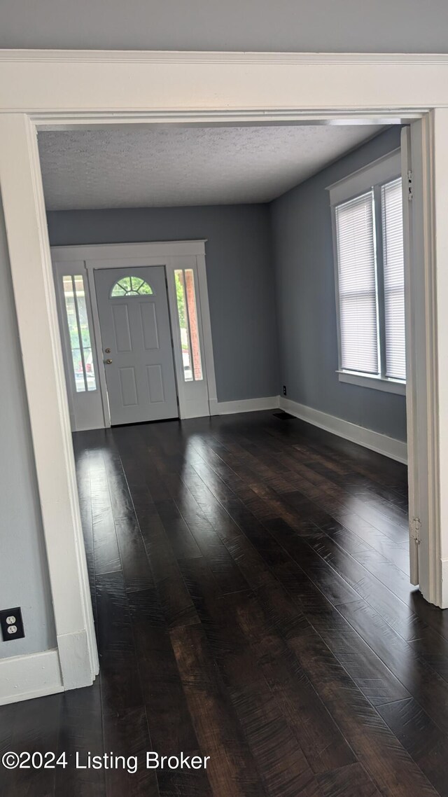 entrance foyer with a textured ceiling and hardwood / wood-style flooring