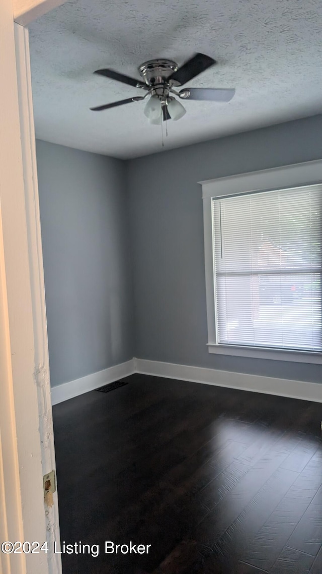 empty room featuring a textured ceiling, ceiling fan, and hardwood / wood-style floors