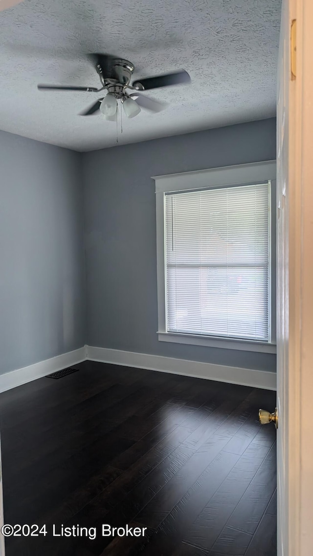 empty room with ceiling fan, a textured ceiling, and hardwood / wood-style flooring