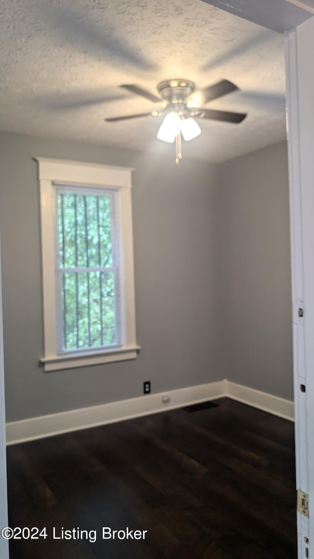 empty room with ceiling fan and hardwood / wood-style floors