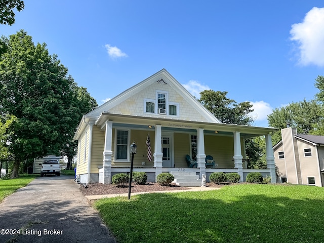 view of front of house featuring a front lawn and covered porch