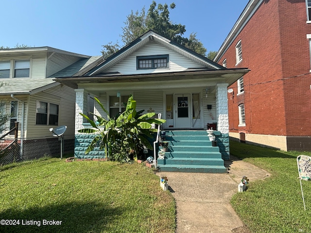 bungalow featuring a porch and a front lawn