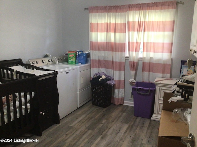 laundry room with dark hardwood / wood-style floors and washing machine and clothes dryer