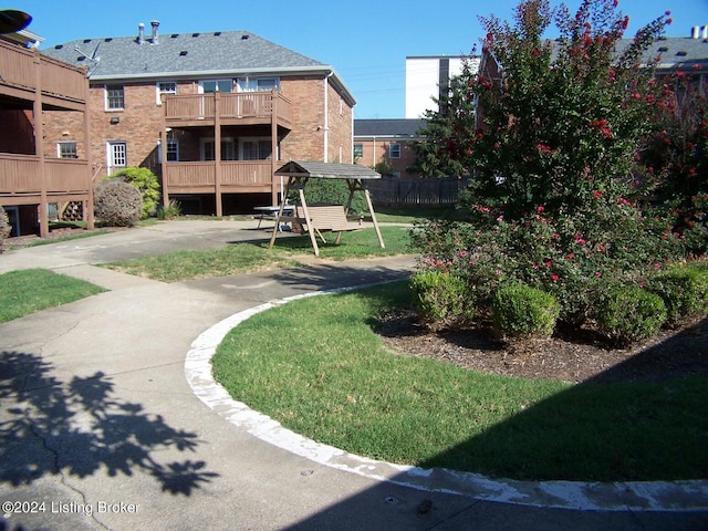 view of property's community with a lawn