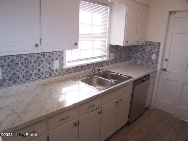 kitchen featuring sink, dark hardwood / wood-style flooring, stainless steel dishwasher, and a healthy amount of sunlight