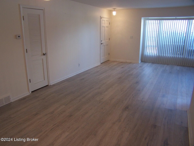 spare room with wood-type flooring